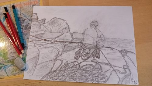 A pencil sketch shows a rock climber with ropes and gear from behind, placed on a wooden desk surrounded by art supplies.